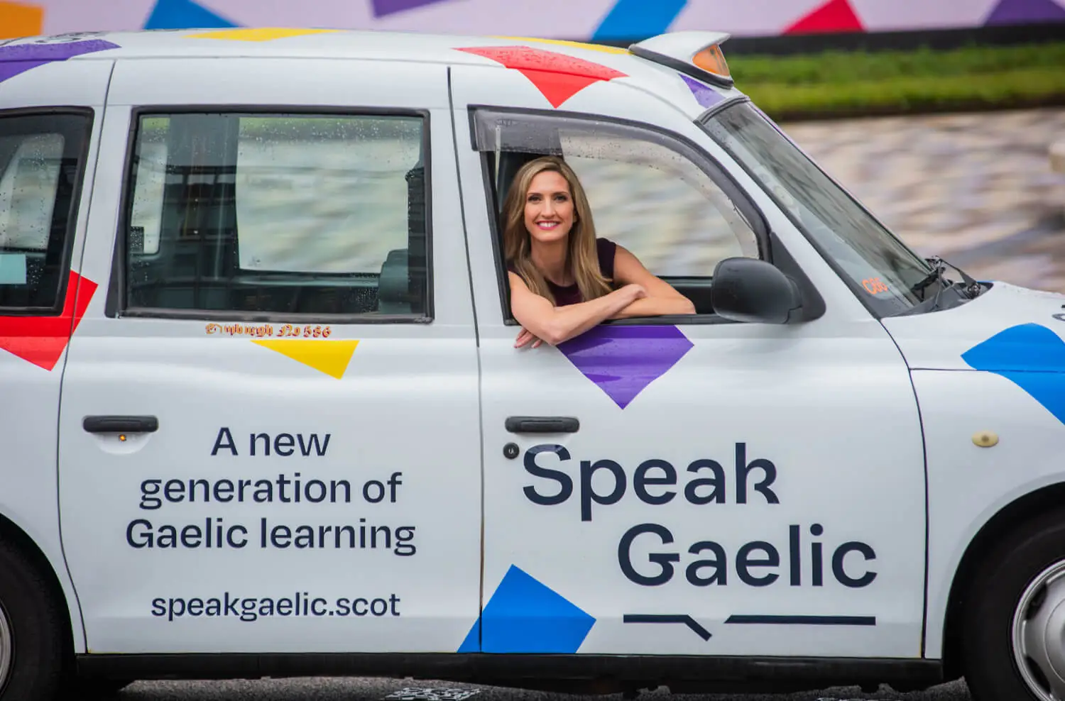 Joy Dunlop in a SpeakGaelic branded taxi